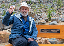Brian Luckman sittin on bench dedicated to him by Parks Canada in the Canadian Rockies