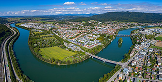 City with river, surrounded by mountains